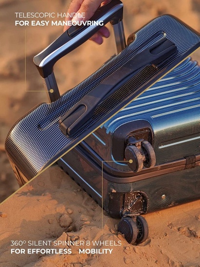 Close-up of the Galisto telescopic handle and 360° silent spinner wheels on a beach surface.
